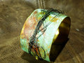 Embossed brass cuff with patina and steel