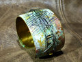 Embossed brass cuff with patina and steel