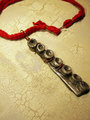 Concrete octopus necklace with recycled red cord