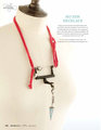 Recycled sewing machine part with hanging charm necklace