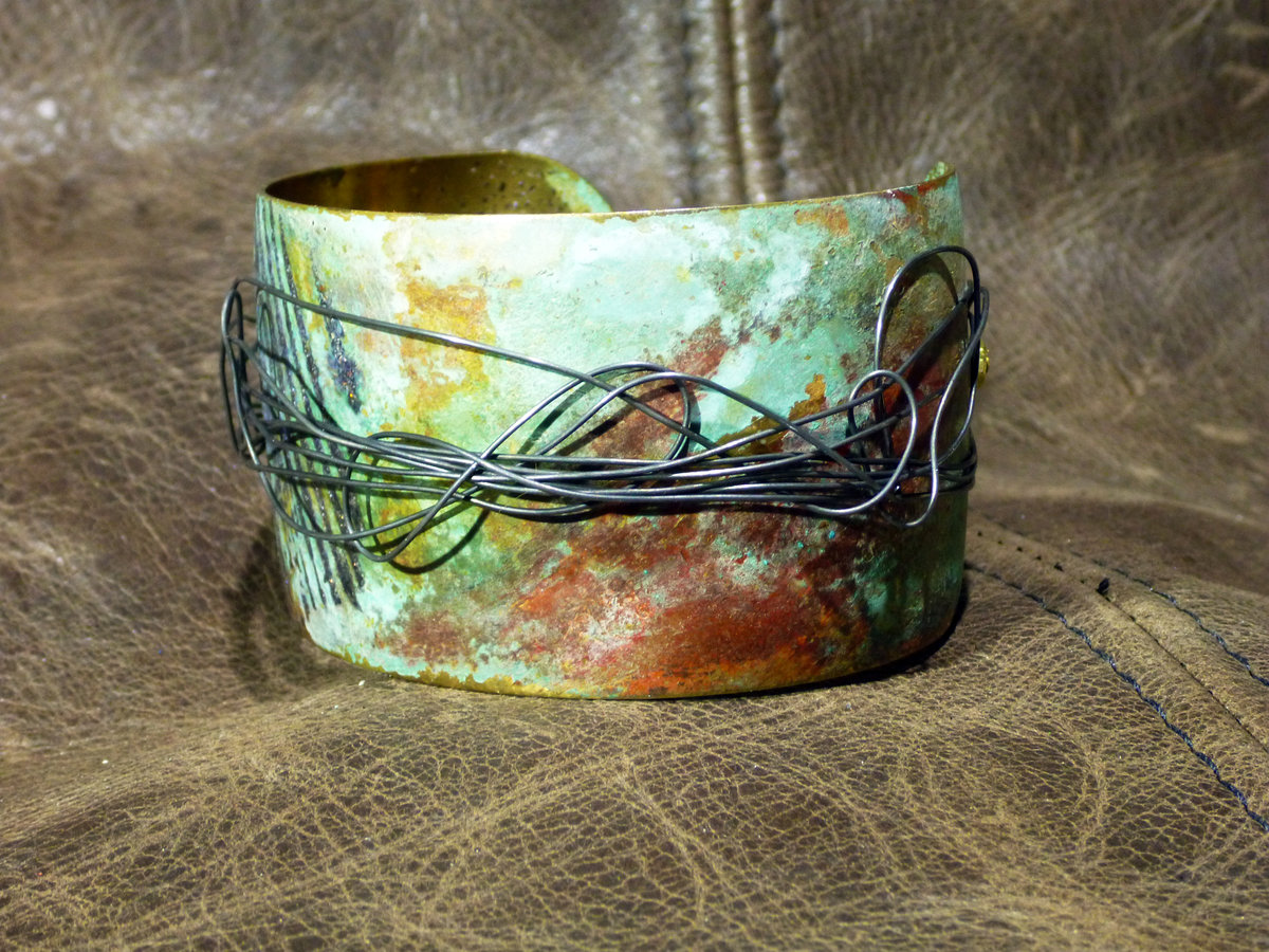 Embossed brass cuff with patina and steel