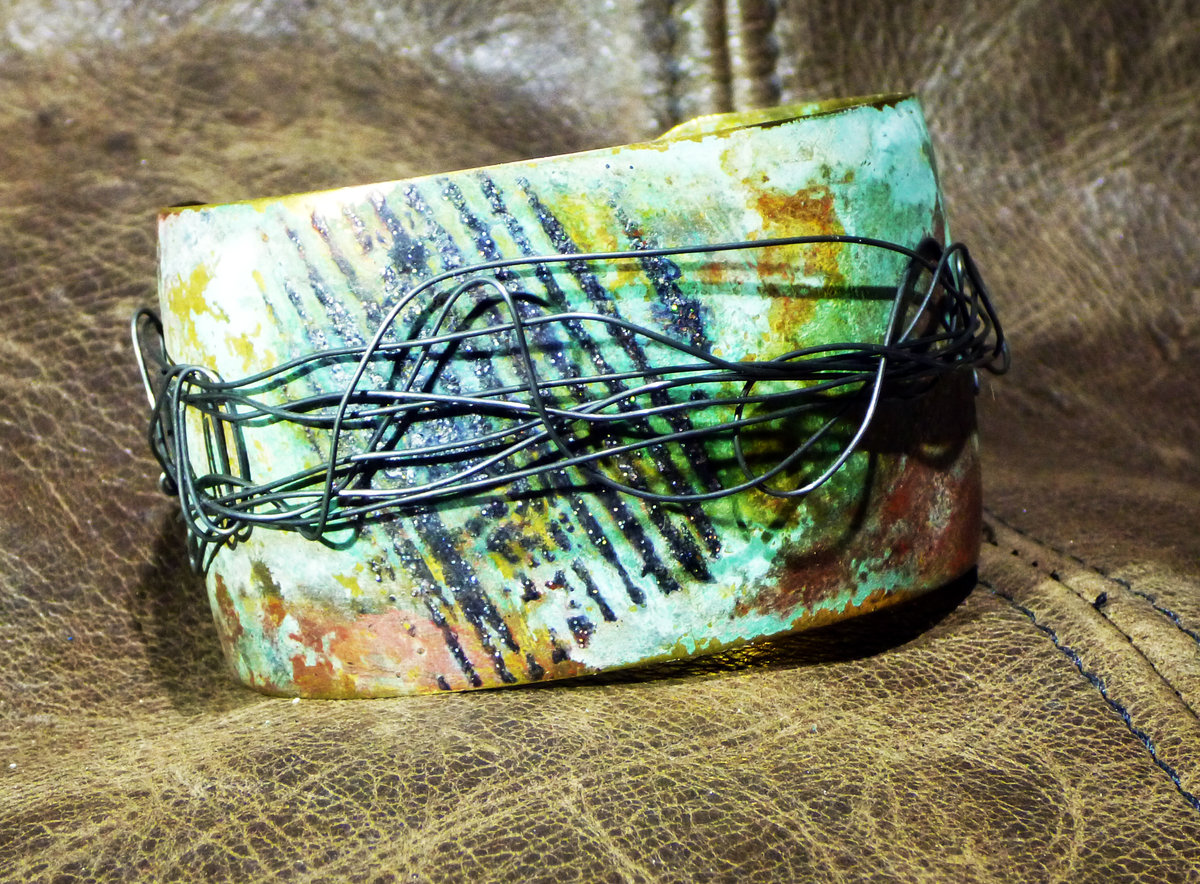 Embossed brass cuff with patina and steel
