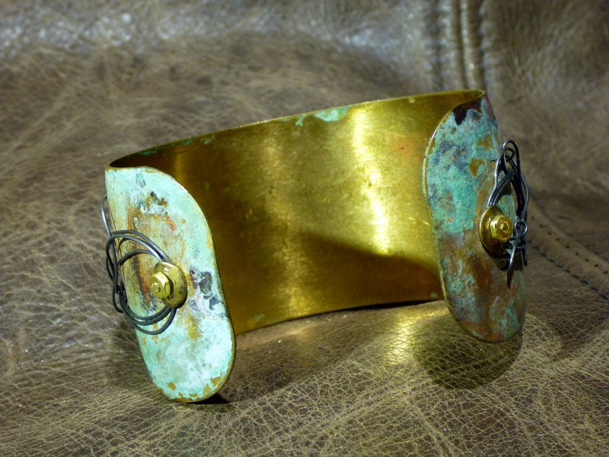 Embossed brass cuff with patina and steel